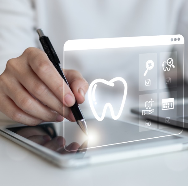 A hand holding a pen hovers over a tablet displaying dental icons and a tooth graphic, signifying digital dental services.