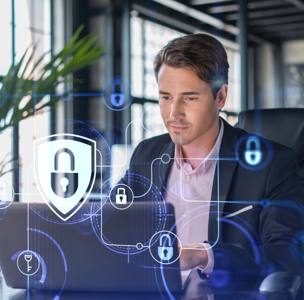 A professional in a suit sits at a laptop, surrounded by digital security icons and lock symbols, emphasizing cybersecurity themes.