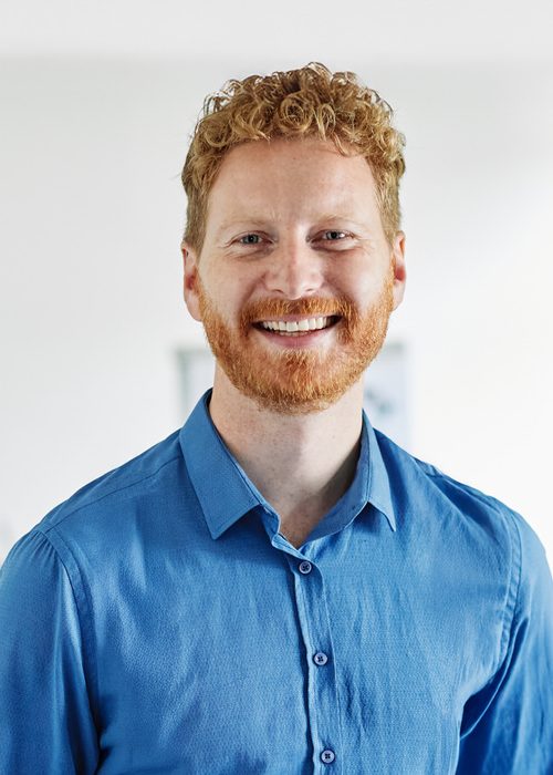 Portrait of a smart young businessman using a tablet computer in the office or classroom. Startup and succesful business concept or education and student concept